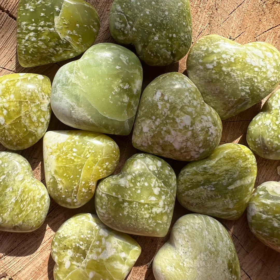Polished serpentine heart stones showing natural green mineral patterns
